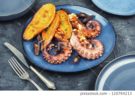 A dish with roasted octopus tentacles. 120764213