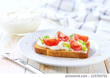 Fresh made cream cheese toast bread with herbs, cherry tomatoes, simple and delicious snack. 120764792