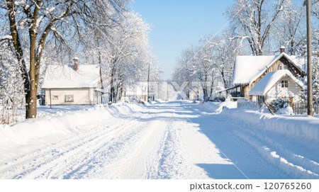 Snowy Village Street with Traditional Houses and Snow-Covered Trees in Winter Snowy Village Street with Traditional Houses and Snow-Covered Trees in Winter 120765260