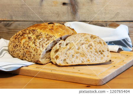 Homemade bread, sourdough wheat loaf with seeds 120765404