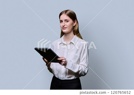 Teenager student girl with digital tablet on grey studio background 120765652