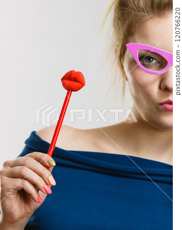 woman holds carnival accessories on stick woman holds carnival accessories on stick 120766220