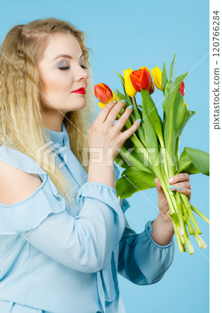 Pretty woman with red yellow tulips bunch Pretty woman with red yellow tulips bunch 120766284
