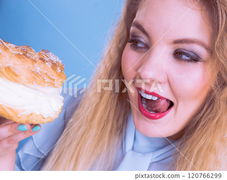Funny woman holds cream puff cake 120766299