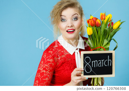 Woman holds tulips, board with text 8 march Woman holds tulips, board with text 8 march 120766308
