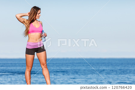 Woman drinking water after sport gym outdoor 120766420