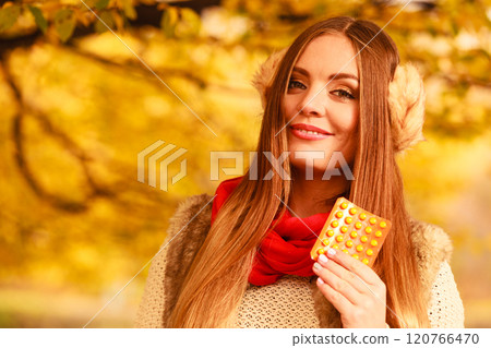 Woman with vitamins for autumn. 120766470