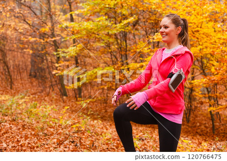 Dynamic girl stretching in forest. 120766475