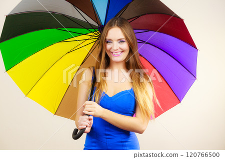 Woman in summer dress holds colorful umbrella 120766500