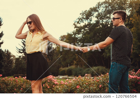 Cheerful girl holding hands in park. 120766504