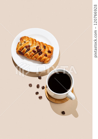 Coffee espresso cup and fresh maple pecan bun pastry on a beige  background with shadow. 120766928