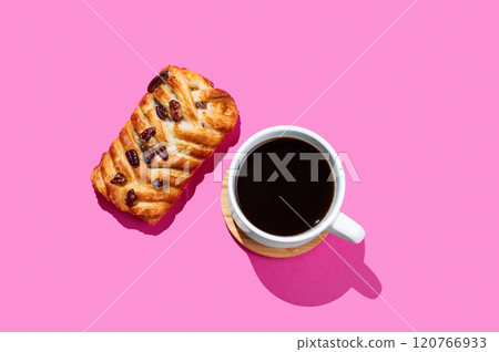 Coffee espresso cup and fresh maple pecan bun pastry on a pink background with shadow. Coffee espresso cup and fresh maple pecan bun pastry on a pink background with shadow. 120766933