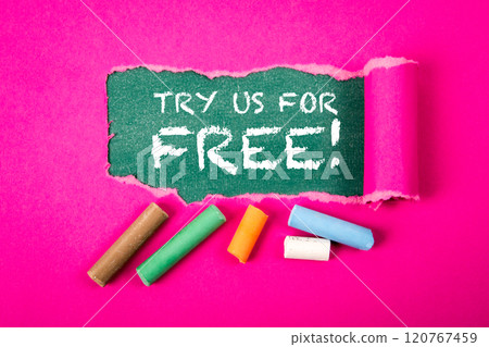 Try Us For Free. Text under torn purple paper on a green chalkboard 120767459