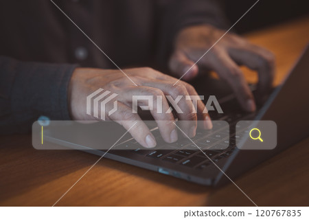 Person types on a laptop keyboard, focusing on a search bar with a magnifying glass icon. Concept of represents online searching, research, and digital information gathering. 120767835