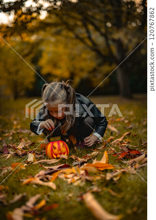 Happy girls 5 years on Halloween with pumpkins in park Happy girls 5 years on Halloween with pumpkins in park 120767862