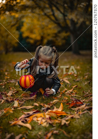 Happy girls 5 years on Halloween with pumpkins in park 120767870