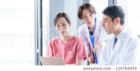 Doctors and nurses using computers 120768959
