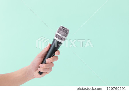 A man's hand holding a microphone (stock photo) 120769291