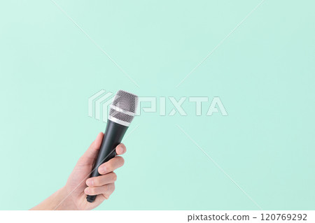 A man's hand holding a microphone (stock photo) 120769292