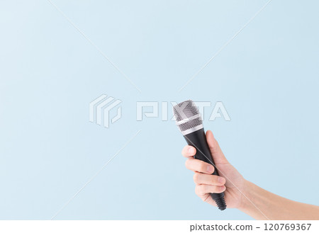 A man's hand holding a microphone (stock photo) 120769367