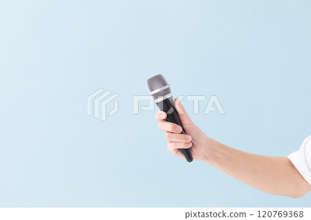 A man's hand holding a microphone (stock photo) 120769368