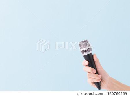 A man's hand holding a microphone (stock photo) 120769369