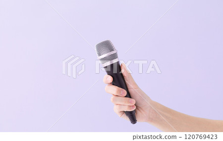A man's hand holding a microphone (stock photo) 120769423