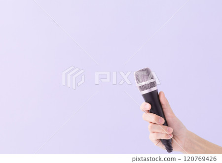 A man's hand holding a microphone (stock photo) 120769426