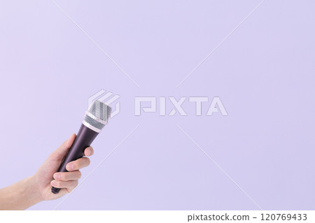 A man's hand holding a microphone (stock photo) A man's hand holding a microphone (stock photo) 120769433