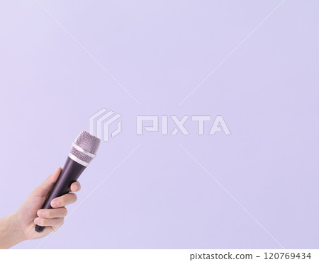 A man's hand holding a microphone (stock photo) 120769434