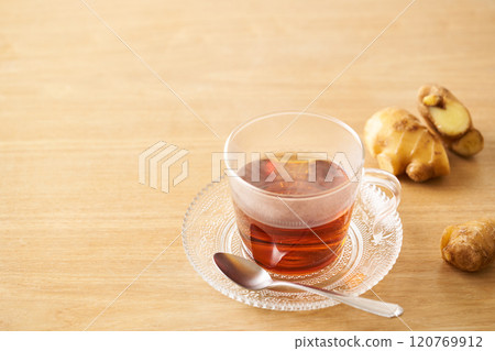 Ginger tea poured into a glass cup 120769912