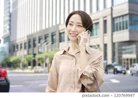 A woman calling on a smartphone outside A woman calling on a smartphone outside 120769997