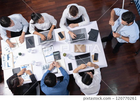 Analyst team utilizing BI Fintech to analyze financial data at table. Prudent 120770261