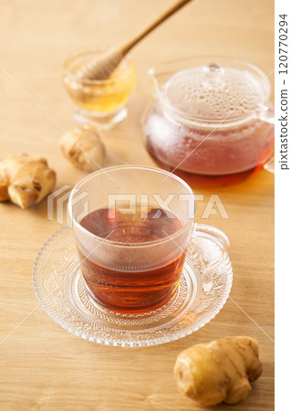 Honey ginger tea poured into a glass cup Honey ginger tea poured into a glass cup 120770294
