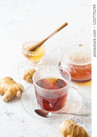 Honey ginger tea poured into a glass cup Honey ginger tea poured into a glass cup 120770299