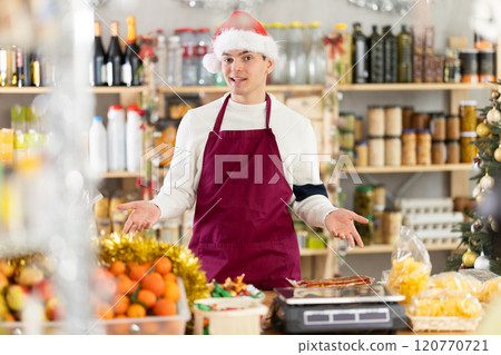 Male salesman behind a grocery counter Male salesman behind a grocery counter 120770721