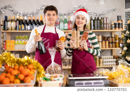 Woman and man sellers offering alcohol and sweets Woman and man sellers offering alcohol and sweets 120770781