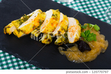 Turkey breast with caramelized onions and prunes served at plate 120770797