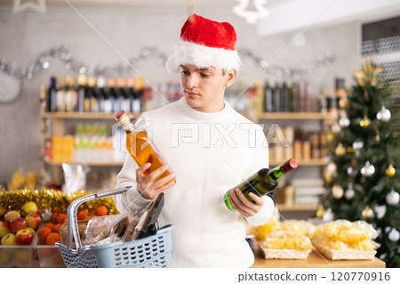 Man in a hat chooses alcohol 120770916