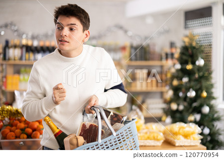 Young guy choosing groceries in store Young guy choosing groceries in store 120770954