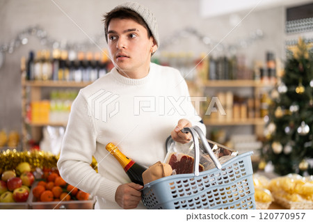 Visiting store on New Years Eve, guy is looking at something on shelf of showcase. 120770957