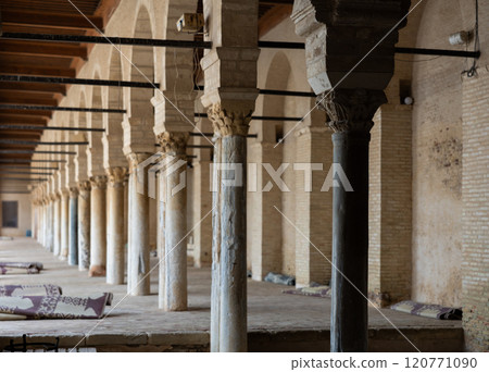Long corridors under vaulted ceiling in ancient mosque of Kairouan in Tunisia. 120771090