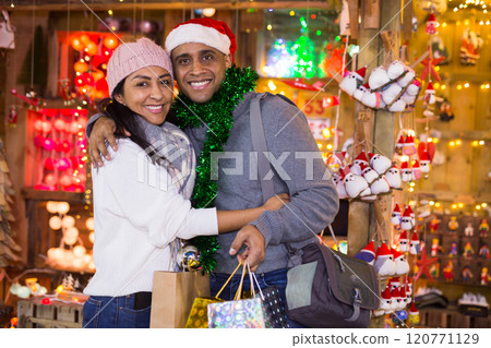 Couple expression happinnes from buying decoration at Christmas fair Couple expression happinnes from buying decoration at Christmas fair 120771129