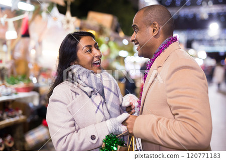 Portrait of happy couple in love at christmas fair Portrait of happy couple in love at christmas fair 120771183