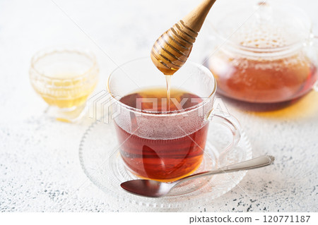 Honey tea poured into a glass cup Honey tea poured into a glass cup 120771187