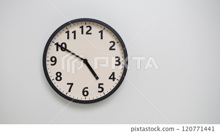 Classic Black-Edged Clock on White Background at 16.50/04.50 - Perfect for Time Management and Text Space 120771441