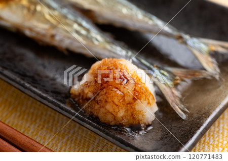 Grilled salted saury served with grated daikon radish Grilled salted saury served with grated daikon radish 120771483