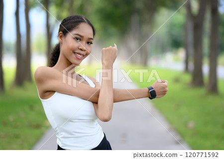 Young slim athletic woman stretching body for morning exercise. Health and fitness concept 120771592