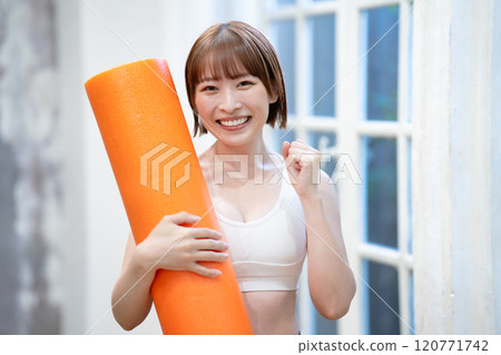 Young woman with stretch pole 120771742