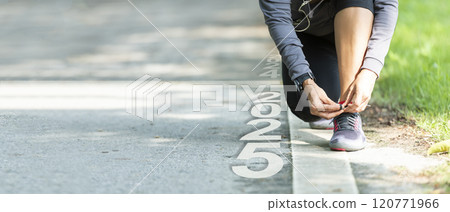 The start into the new year 2025. Start up of runner woman running on nature race track  120771966